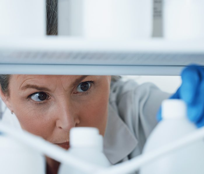 Laboratory, research and woman with bottles on a shelf, check information, medical and science. Hea.